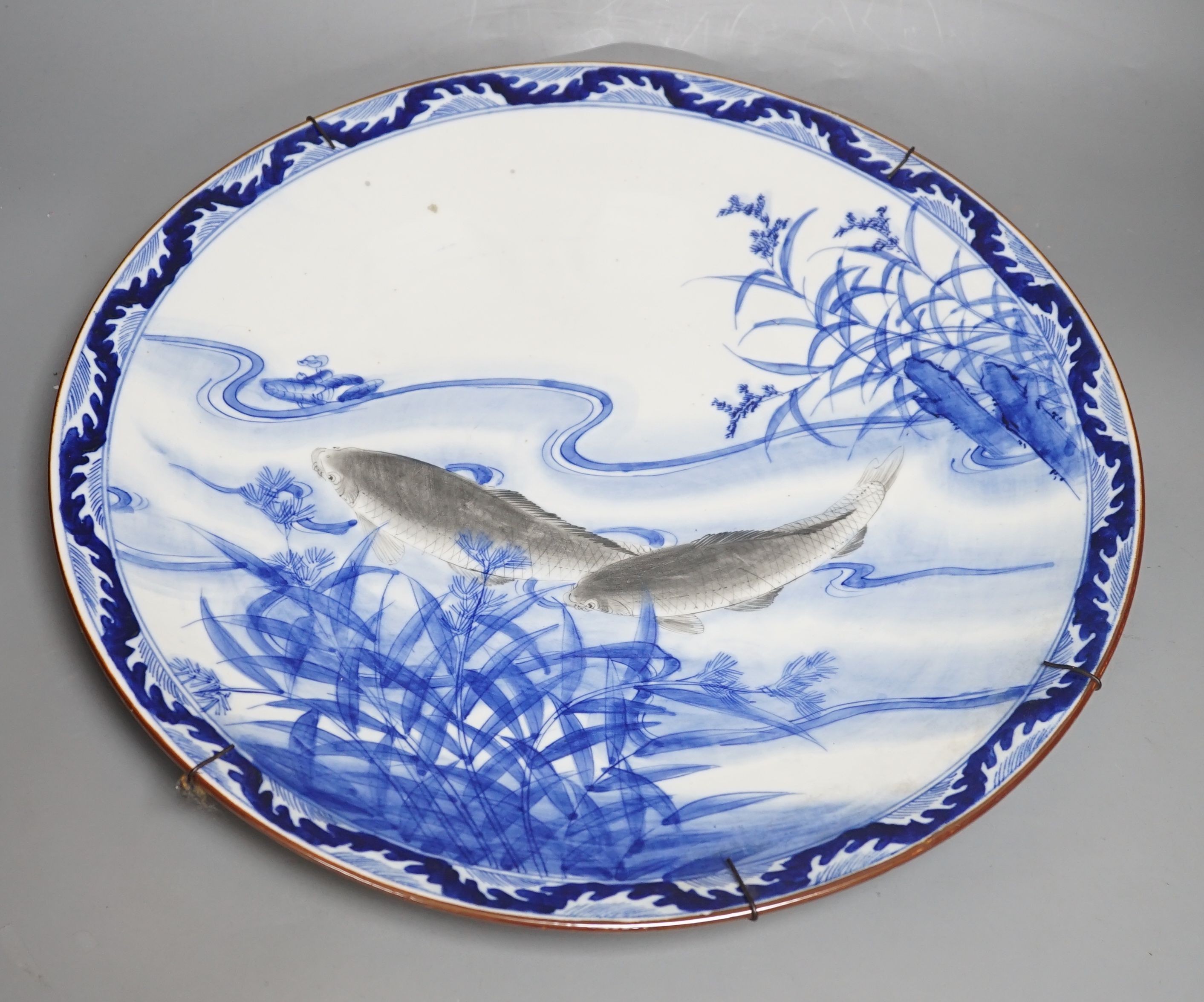 A Japanese porcelain ‘fish’ charger, 46cm